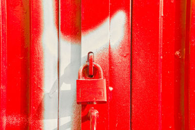Red padlock on red and white door