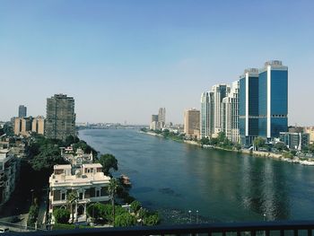 Modern buildings in city against clear sky