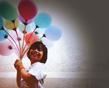 Portrait of happy girl with balloons