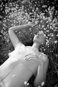 Woman lying among harestail grass