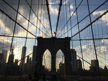 Low angle view of brooklyn bridge against sky in city