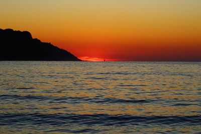 Scenic view of sea against orange sky