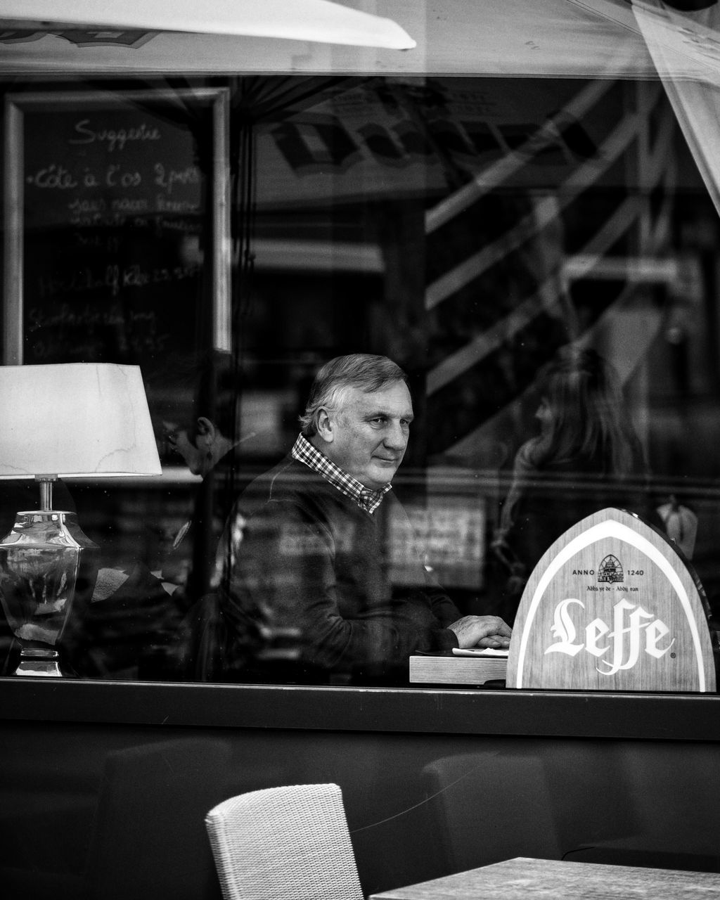 real people, reflection, one person, window, transparent, glass - material, business, adult, lifestyles, women, restaurant, communication, looking, portrait, store, table, retail, waist up, indoors, retail display, display cabinet