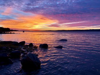 Scenic view of sea against romantic sky at sunset