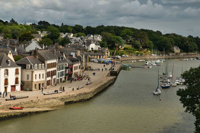 High angle view of townscape by river against sky