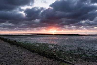 Scenic view of sea against dramatic sky