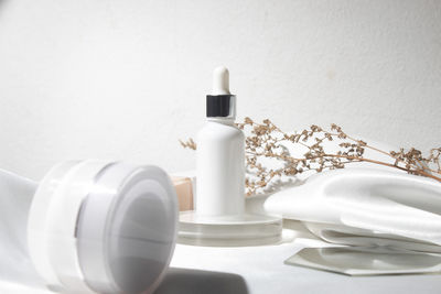 Close-up of white bottle on table