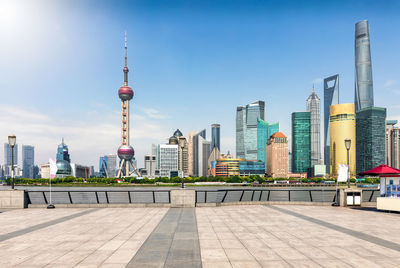 View of modern buildings against sky in city during sunny day