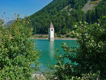 The bell tower of the former church of curon venosta in lake resia, south tyrol, italy.