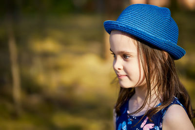 Close-up of girl wearing hat looking away