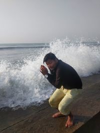 Young man looking at sea shore