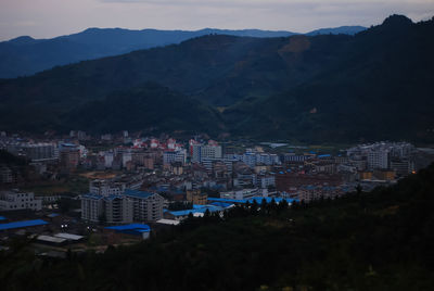 High angle view of illuminated buildings in city at night