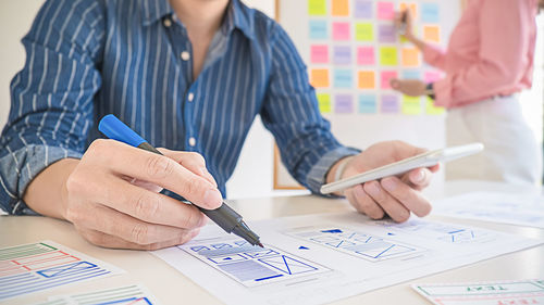Midsection of woman holding paper with text on table