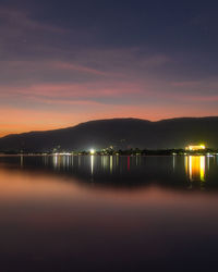 Scenic view of lake against sky at night