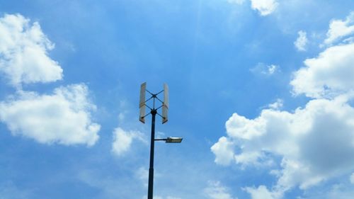 Low angle view of windmill against blue sky