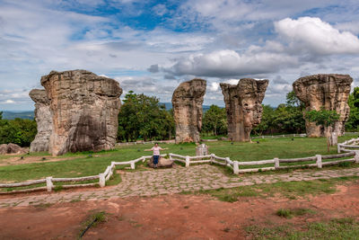 Old ruins on rock against cloudy sky