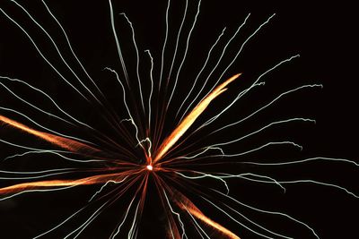 Low angle view of firework display against sky at night