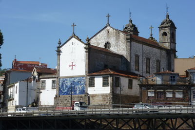 View of old church with tiled exterior against sky in portugal.