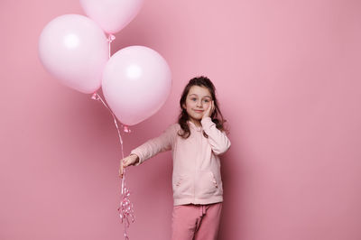 Young woman holding balloons