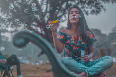 Young woman smiling while holding water