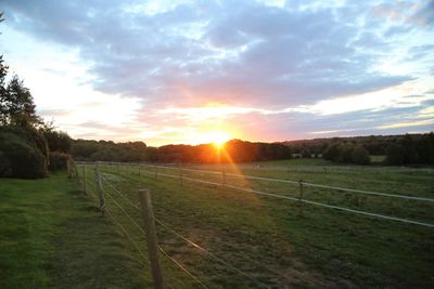 Scenic view of field against sky during sunset