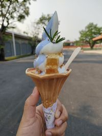 Cropped hand holding ice cream cone