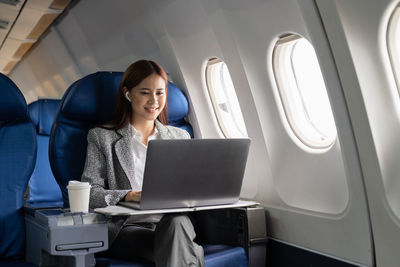 Businesswoman using laptop while sitting in car