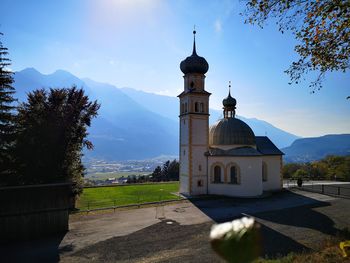 Church by building against sky