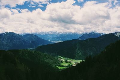 Scenic view of mountains against cloudy sky