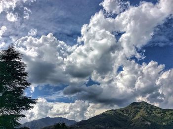 Scenic view of mountains against cloudy sky