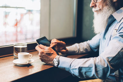 Man and coffee cup on table at cafe