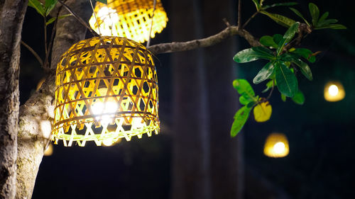 Low angle view of illuminated lanterns hanging at night