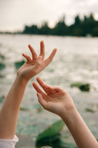 Cropped image of woman hand against blurred background