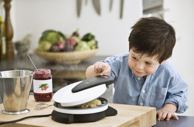 Boy checking waffle-iron