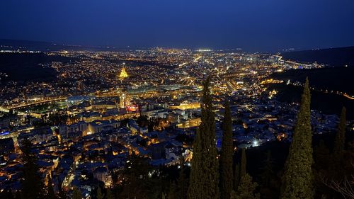 High angle view of illuminated buildings in city at night