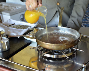 Midsection of man preparing food in kitchen