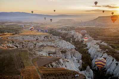 View of hot air balloon flying over landscape