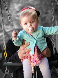 Portrait of cute baby girl with majestic eyes sitting outdoors