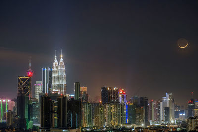 Illuminated buildings in city at night