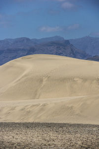 Scenic view of desert and mountains against sky