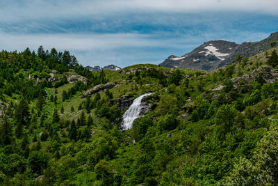 Scenic view of waterfall against sky