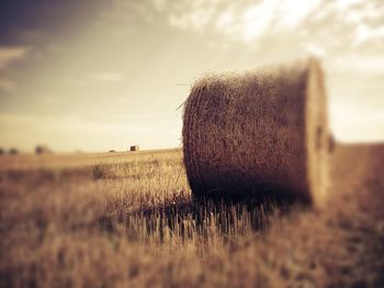 Scenic view of field against cloudy sky