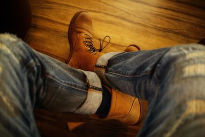 Low section of man sitting on wooden floor