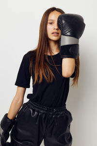 Young woman with blond hair against white background