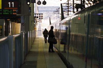 People walking on railroad station platform