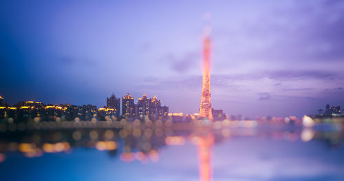 Reflection of buildings in city at night