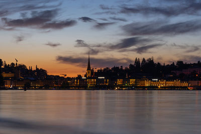 View of buildings against cloudy sky at sunset