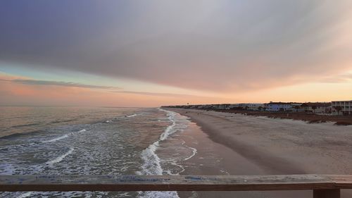 Scenic view of beach against sky during sunset