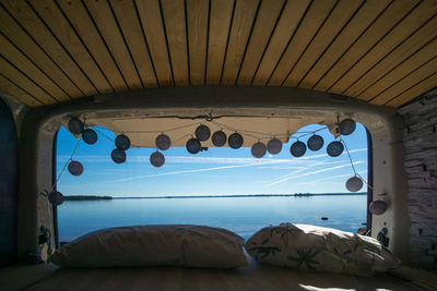 Low angle view of sea seen through window