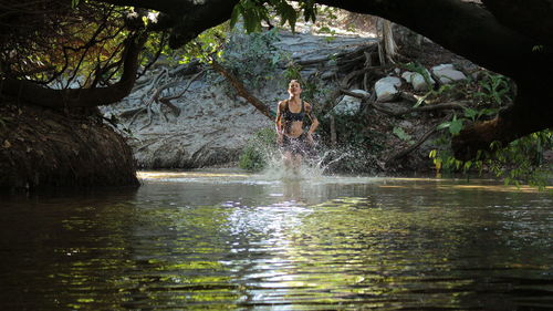 Woman wading in lake